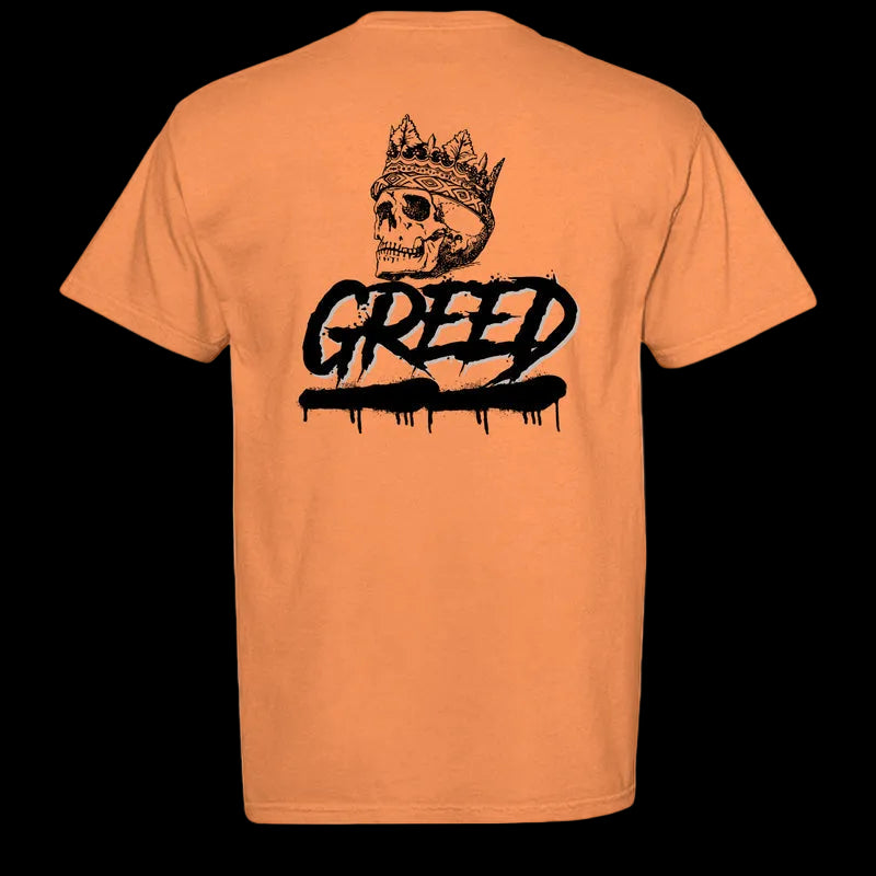 Orange t-shirt with a black graphic design of a skull wearing a crown and the word 'Greed'