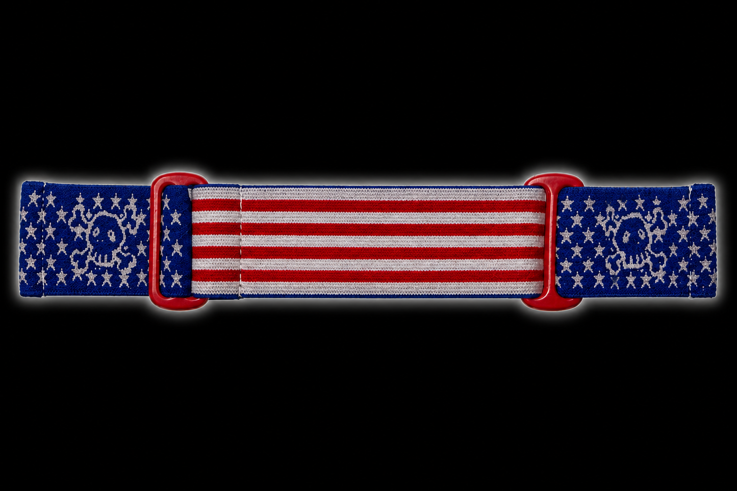 JT Flex paintball goggle strap featuring an American flag design with a GREED twist. Featuring red and white stripes, blue star panels, woven skull graphics, and red adjustment loops.