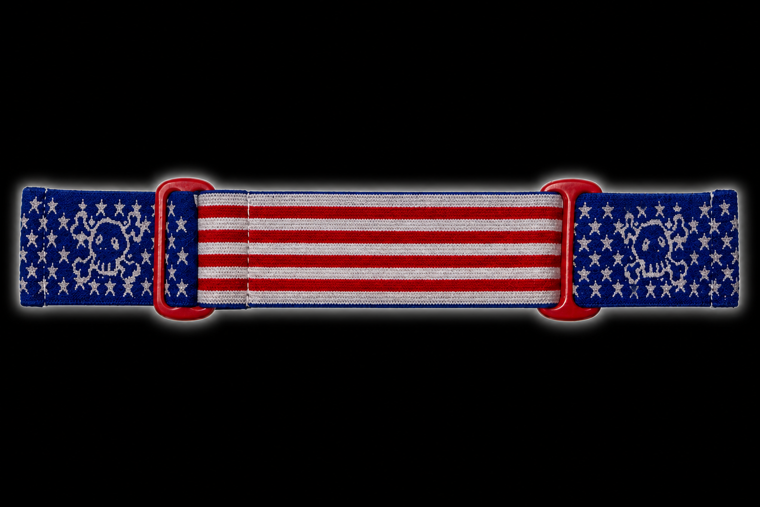 JT Flex paintball goggle strap featuring an American flag design with a GREED twist. Featuring red and white stripes, blue star panels, woven skull graphics, and red adjustment loops.